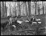 Girls [eating] lunch in [the] woods, 24 May, 1907 24 May 1907