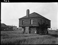 Man standing in front of the Clergue Blockhouse, Sault Ste. Marie, Ontario, 1908 1908.