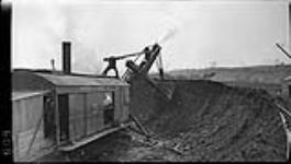 Steam shovel (digging out) bank near Lock 4, (during the construction of the new) Welland Canal 17 Apr. 1914