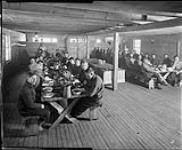 A logging camp, men eating 1917
