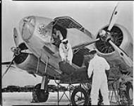 [Unloading of airmail from Lockheed 14-H2 aircraft CF-TCK of Trans-Canada Air Lines, Winnipeg, Man., April 1940.]