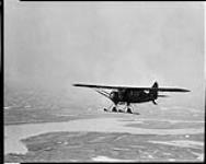 [Bellanca 'Pacemaker' aircraft of Commercial Airways Ltd. flying over the Mackenzie River, N.W.T., 1930.]