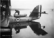 [Personnel inflating dinghy carried in Canadian Vickers 'Vancouver' II flying boat G-CYVU of the R.C.A.F., Rockcliffe, Ont., 25 November 1931.] 25 Nov. 1931