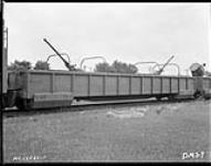 Side view of gondola car of armoured train showing anti-aircraft guns and search-light, Canadian National Railways Shops 15 July 1942