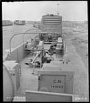 Interior view of gondola car of armoured train showing anti-aircraft guns, Canadian National Railways Shops 15 July 1942