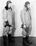Unidentified airmen modelling two types of flying suits, Test and Development Establishment, R.C.A.F. Station Rockcliffe, Ontario, Canada, 12 January 1943 January 12, 1943
