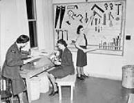 Unidentified airwomen at the opening of the Station Craft Shop, R.C.A.F. Station Rockcliffe, Ontario, Canada, 25 January 1944 January 25, 1944