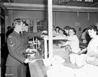 Unidentified airwomen lining up in the cafeteria, No.1 Repatriation Depot (Canadian Army Miscellaneous Units), Royal Canadian Air Force Station Rockcliffe, Ontario, Canada, 24 April 1944 April 24, 1944.