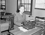 Corporal Helen Grice of the Royal Canadian Air Force (R.C.A.F.) Women's Division working in the Orderly Room of No.168(HT) Squadron, Rockcliffe, Ontario, Canada, 1 March 1944 March 1, 1944.