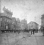 Street view, moving building ca. 1875