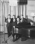 [Singers and pianist at a microphone for a CKGW broadcasting. (First from left: Ernest Morgan who became CBC Producer).] ca. 1925 - 1933
