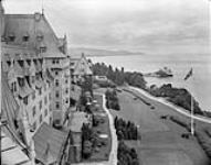 Canada Steamship Lines' Manoir Richelieu at Murray Bay. View of hotel's facade, terrace and CSL passenger ship ST.LAWRENCE at wharf ca. 1930's