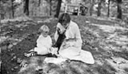 Edna [Boyd] and young girl with a black squirrel [ca. 1916].