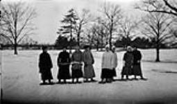 Eight girls in a line snowshoeing in the park, 10 Feb., 1917 February 10, 1917.