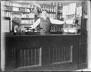 Mr. E.L.B. Joseph in Dr. Riddell's drugstore, Lots 14 and 15, Block 1, Lauder, Man., Taken 1914-1918 n.d.