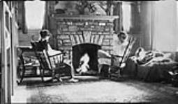 Figures before the fireplace at the Boyd cottage, Bala, [Ont.] 17 Aug., 1917
