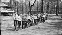 Boys cleaning their teeth at the Forest School in High Park, [Toronto, Ont.], 13 June, 1917 June 13, 1917.