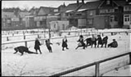 Boys and girls in a yard on Geoffrey Street playing tug-of-war, [Toronto, Ont.], 16 Feb., 1918 16 Feb. 1918