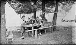 Flax pulling : grils eating dinner at Camp Determination July 25, 1918.