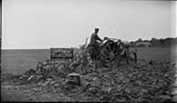 Gilson tractor with cockshutt plow during a tractor demonstration at Cobourg, [Ont.], 18 Sept., 1918 18 SEPT., 1918