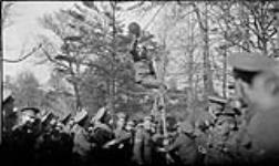37th Battalion with a man up a pole in High Park 30 Oct. 1915