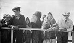 After the treaty dance. Everything starts breaking up and people leave. Dogrib youths watching mission schooner GUY leaving 1937