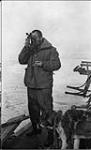 G. Mallock with a sextant taking observations on the voyage north 1913 - 1914