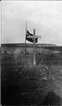 The grave of Mallock and Mamen at Rogers Harbor, Wrangell Island, [Alaska], with flag at half mast, August 1914 1913 - 1914