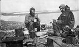 J. Munro and Templeman having tea and eating seal meat at Rogers Harbor, Wrangell Island June 1914