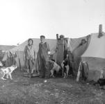 [Benjamin Abraham and his Inuk wife with children and dogs at their home at Fort George] Original Title: Benjamin Abraham has married an Eskimo woman. This is a good picture of their home at Fort George 1949