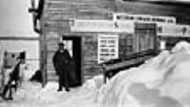 Western Canada Airways' first office at Hudson. The man in the doorway is J.A. McDougall, Treasurer of Western Canada Airways Dec. 1926