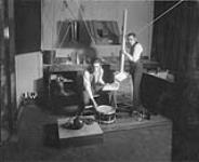 Messrs. Vic George and Herb Roberts creating sound effects for the 'Henry Hudson' program of the 'Romance of Canada' Series, Montreal, P.Q., January, 1931 January, 1931