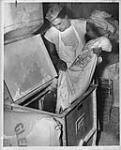Toronto baker pouring flour into sifting machine Sept. 1947