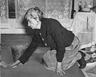 Old age pensioner scrubbing floors to supplement her allowance June 1947