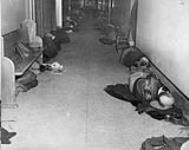 Men sleeping in corridor, March, 1952 Mar. 1952