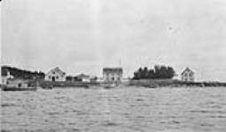 The H.B. Co. Post at Osnaburgh House showing the store to the left, the residence in the centre with the tents for the Treaty party and the servants' home, Lake St. Joseph, Ont c.a. 1929