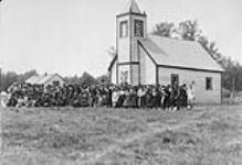 Indians of the English River band taken in front of the Anglican Church immediately after the Treaty payments