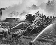 Fire was out of control until the arrival of the bulldozer. Fire in Gillies Bros. lumber yard in Braeside 17 August 1949