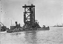 Can. Stewart Co's dredge "Cyclone" coming in with speed broken. Old Western channel, Toronto, Ont Oct. 7, 1916