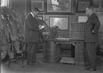 Thomas T. Hawkins, portraying a "Case Examiner", totalling up the results of John H. (Jack) Roberts' annual examinations as a Railway Mail clerk ca. 1920