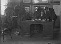 During Railway Mail clerk's annual examinations. John H. (Jack) Roberts on left with Thomas T. Hawkins, actors ca. 1920