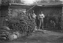 Gordon Hall left and Dick Hall at their home on Moose Point, Lac La Ronge c. 1930