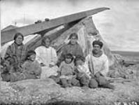 Natives at Hudson Bay Company Post, Southampton Island, N.W.T. August, 1926 [The man has been identified as Kootoo and the woman in the shawl has been identified as Kanayuq] 1926.