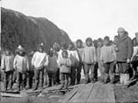 [Inuit children with Douglas Robertson of Toronto Telegram on right] Original title: Native group - Douglas Robertson of Toronto Telegram on right September 1931