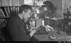 Richard Finnie typing notes at his "Kogluktuk" base January 1931.