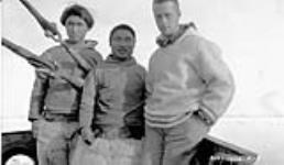 [Inuuk men Sadluck (left) and Kaingak (centre) with Richard Finnie (right) on board the "Beothic"]. Original title: L to R: Eskimos Sadluk and Kaingak with Richard Finnie on board the "Beothic" 1928
