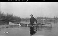 Buffalo Lake - taking coney out of nets in Whitesand River, N.W.T 1938.
