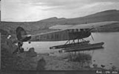 Mat Berry's plane near N.A.M.E. [Northern Aerial Minerals Exploration] camp just after flight from Coppermine 2 July 1931