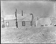 H.B. [ Hudson's Bay] Co. Post, Cape Dorset - J.D. Soper's snowhouse observatory in right foreground December 1928.