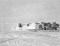 Two Inuks building an igloo in central Foxe Land March 1929.